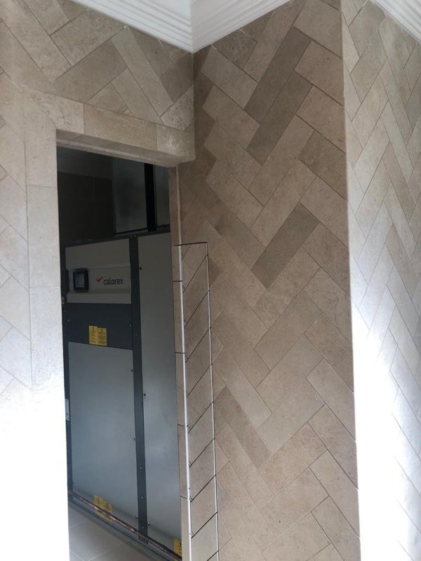 Herringbone wall tiling around the doorway to a plant room