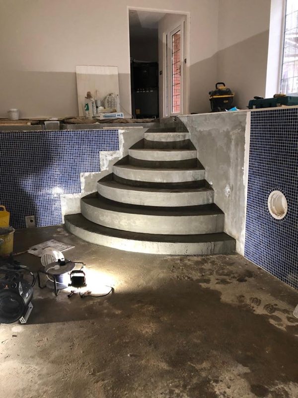 Curved steps being formed in an indoor pool before final tiling