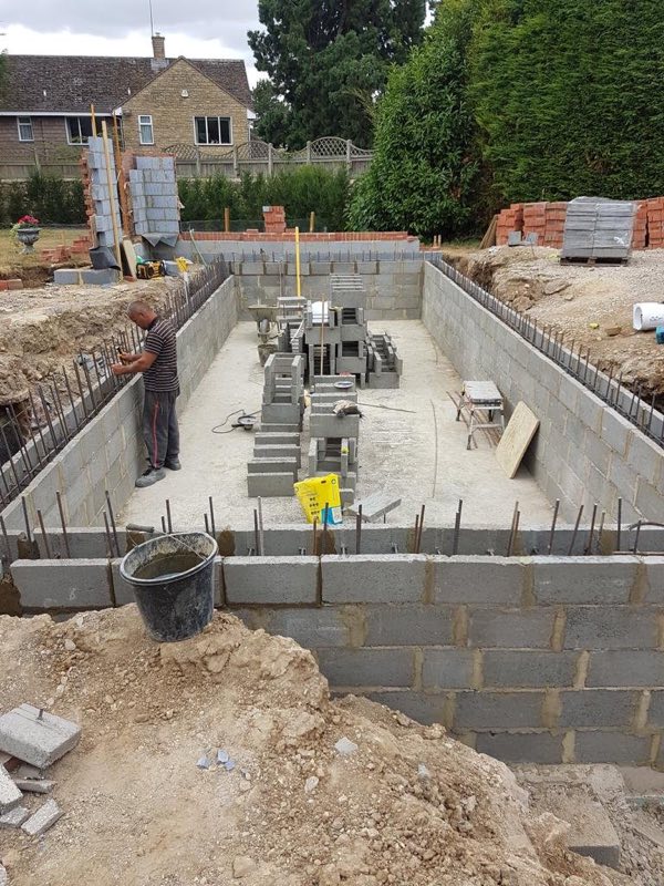 Blockwork walls of a new pool shell rising on site