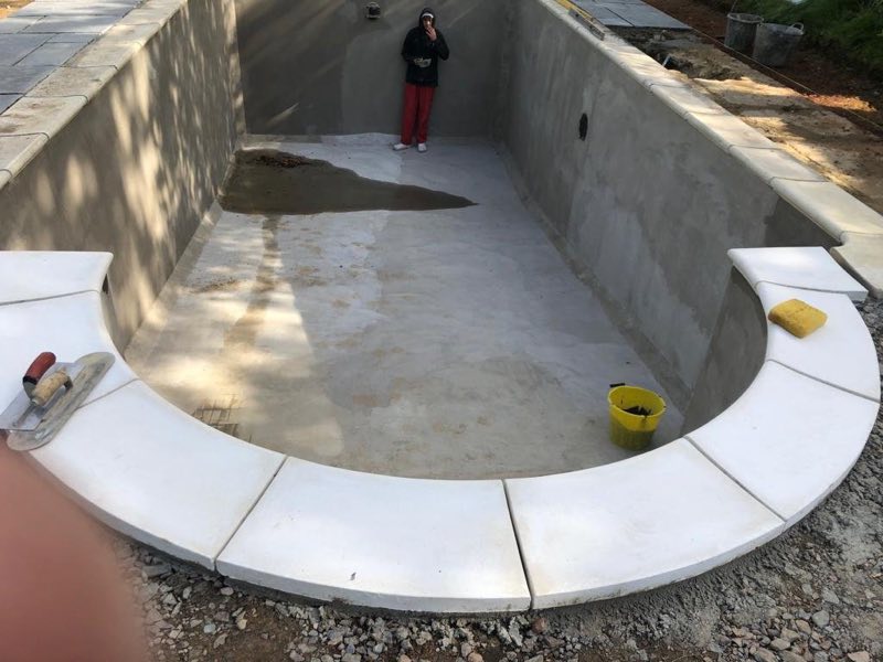 Curved Roman-end steps with white coping, before tiling
